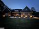 Charming single-story home with a manicured lawn and cozy front porch lit up at night at 227 Wet Wood Ct, Fairburn, GA 30213