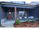 Inviting front porch adorned with a seating area, stylish decor, and well-maintained landscaping, enhancing the home's appeal at 227 Wet Wood Ct, Fairburn, GA 30213