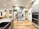 Gray kitchen cabinets, modern refrigerator, large pantry and stainless appliances in a spacious kitchen at 227 Wet Wood Ct, Fairburn, GA 30213