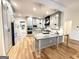 Beautiful kitchen boasts gray cabinets, a large island, and stainless steel appliances at 227 Wet Wood Ct, Fairburn, GA 30213