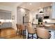 Kitchen with gray cabinets, stainless appliances, island seating, and pendant lighting at 227 Wet Wood Ct, Fairburn, GA 30213