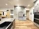 Open kitchen with gray cabinets, large island, stainless steel appliances and bar seating at 227 Wet Wood Ct, Fairburn, GA 30213