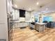 Spacious open concept kitchen features gray cabinets and island with stainless steel appliances at 227 Wet Wood Ct, Fairburn, GA 30213