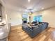 Bright living room with fireplace, gray sectional sofa, and an open layout with the kitchen at 227 Wet Wood Ct, Fairburn, GA 30213