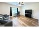 Cozy living room with comfortable seating, a modern ceiling fan, and a flat-screen television at 227 Wet Wood Ct, Fairburn, GA 30213