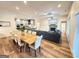 Open floor plan showcases a dining area, kitchen, and living room with a cozy fireplace at 227 Wet Wood Ct, Fairburn, GA 30213