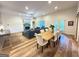 Open-concept living area combining a dining table and a comfortable seating area, ideal for entertaining and Gathering time at 227 Wet Wood Ct, Fairburn, GA 30213