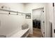 Bright mudroom boasts a bench with storage, coat hooks, and a view into the laundry area with modern appliances at 227 Wet Wood Ct, Fairburn, GA 30213