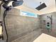 Walk-in shower featuring sleek gray tile, a herringbone-patterned floor, and modern fixtures at 227 Wet Wood Ct, Fairburn, GA 30213