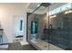 Walk-in shower with gray tiling, herringbone floor, a view of the bedroom, and a glass partition at 227 Wet Wood Ct, Fairburn, GA 30213