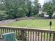 Spacious backyard with a wooden fence, seen from a deck with string lights at 840 Yosemite Dr, Suwanee, GA 30024