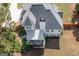 Aerial view of a well-maintained home with a striped awning covered patio, lush landscaping, and a pristine roof at 150 Murphy Creek Ln, Fayetteville, GA 30215