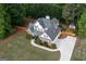Gorgeous aerial view of a brick and siding two-story home with a landscaped yard, driveway, and wood perimeter fence at 150 Murphy Creek Ln, Fayetteville, GA 30215