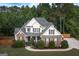 Inviting aerial view showcases a two-story home with a lush yard, complemented by a driveway and fenced perimeter at 150 Murphy Creek Ln, Fayetteville, GA 30215