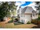 Expansive backyard featuring a deck, covered patio swing, lush lawn, and shed, perfect for outdoor enjoyment at 150 Murphy Creek Ln, Fayetteville, GA 30215