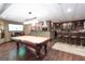 Finished basement with a billiard table, bar and billiard cue rack at 150 Murphy Creek Ln, Fayetteville, GA 30215