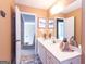 The bathroom boasts a dual sink vanity, a large mirror, and neutral tan walls at 150 Murphy Creek Ln, Fayetteville, GA 30215