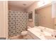 Neutral bathroom featuring shower with patterned curtain, toilet, vanity, and large mirror at 150 Murphy Creek Ln, Fayetteville, GA 30215