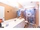 This bathroom features a vanity with a large mirror and a blue floral shower curtain at 150 Murphy Creek Ln, Fayetteville, GA 30215