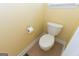 Cozy powder room with neutral tile floors, toilet, baseboards and window letting in natural light at 150 Murphy Creek Ln, Fayetteville, GA 30215