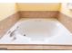 Close up on the jetted tub with tile surround at 150 Murphy Creek Ln, Fayetteville, GA 30215
