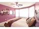 This bedroom has purple walls, a ceiling fan, bay windows, and shelving to add character and charm at 150 Murphy Creek Ln, Fayetteville, GA 30215
