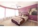 Stylish bedroom with purple accent wall, ceiling fan, carpeted floor and natural light at 150 Murphy Creek Ln, Fayetteville, GA 30215
