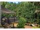 Relaxing covered deck featuring a comfortable outdoor seating area, ideal for enjoying the serene green surroundings at 150 Murphy Creek Ln, Fayetteville, GA 30215