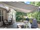 Inviting outdoor deck with awning, grill, and comfortable seating area at 150 Murphy Creek Ln, Fayetteville, GA 30215