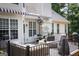 Well-appointed deck with a grill, comfortable seating, and a black awning for shade at 150 Murphy Creek Ln, Fayetteville, GA 30215