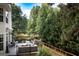 Outdoor deck featuring a comfortable lounge area, grill, and a view of the lush green backyard at 150 Murphy Creek Ln, Fayetteville, GA 30215