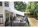Charming deck with comfortable seating, lush greenery, and an awning, perfect for outdoor entertaining and relaxation at 150 Murphy Creek Ln, Fayetteville, GA 30215