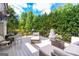Spacious deck featuring an outdoor grill, stylish furniture, and lush green backyard at 150 Murphy Creek Ln, Fayetteville, GA 30215
