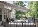 Outdoor deck featuring comfortable seating, an awning, and a grill, creating an inviting space for relaxation and enjoyment at 150 Murphy Creek Ln, Fayetteville, GA 30215