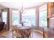 Cozy dining area featuring a chandelier, a window view, and a table set for four at 150 Murphy Creek Ln, Fayetteville, GA 30215