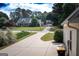 Long driveway leading to homes in a quiet neighborhood with well-maintained lawns and mature trees at 150 Murphy Creek Ln, Fayetteville, GA 30215