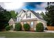 Lovely home exterior featuring manicured shrubs, brick accents, and a well-maintained lawn at 150 Murphy Creek Ln, Fayetteville, GA 30215