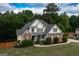 Inviting traditional home with a well-maintained lawn, mature landscaping, and a charming brick and siding facade at 150 Murphy Creek Ln, Fayetteville, GA 30215