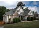 Charming home featuring brick and siding, complemented by a well-manicured lawn and established greenery at 150 Murphy Creek Ln, Fayetteville, GA 30215