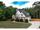 Well-kept two-story home featuring brick accents, a lush lawn, driveway, and bordered by a wooden privacy fence at 150 Murphy Creek Ln, Fayetteville, GA 30215