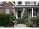 Inviting front entrance with a dark front door, decorative wreath, manicured shrubbery, and a welcoming porch at 150 Murphy Creek Ln, Fayetteville, GA 30215