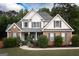 Charming two-story home with a brick facade, gray shutters, manicured landscaping, and a welcoming front porch at 150 Murphy Creek Ln, Fayetteville, GA 30215