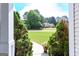 Inviting view of the beautiful landscaping and well-manicured lawn from the front porch at 150 Murphy Creek Ln, Fayetteville, GA 30215