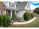 Home featuring manicured landscaping, a curved walkway, and a welcoming front porch with decorative columns at 150 Murphy Creek Ln, Fayetteville, GA 30215