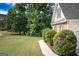Beautifully landscaped front yard with lush green grass, mature trees, and a charming walkway leading to the house at 150 Murphy Creek Ln, Fayetteville, GA 30215