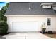 Attached two car garage with a white door and light siding, providing convenient and secure parking at 150 Murphy Creek Ln, Fayetteville, GA 30215