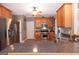 Well-equipped kitchen boasts stainless steel appliances and dark countertops with traditional wood cabinets at 150 Murphy Creek Ln, Fayetteville, GA 30215