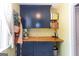 Charming laundry room with blue cabinets, butcher block countertop, and open shelving at 150 Murphy Creek Ln, Fayetteville, GA 30215