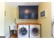 Bright laundry area featuring side-by-side washer and dryer, ample shelving, and storage at 150 Murphy Creek Ln, Fayetteville, GA 30215