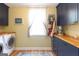 Modern laundry room with wooden counters, blue cabinets, window and washer dryer hookups at 150 Murphy Creek Ln, Fayetteville, GA 30215